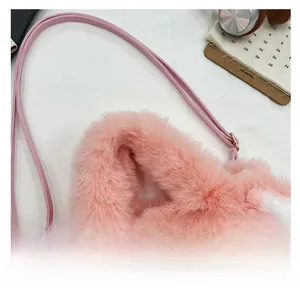 Close-up of pink faux fur texture and animal embroidery on the shoulder bag detail