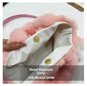 Detail view of pink faux fur handbag featuring secure golden magnetic snap closures