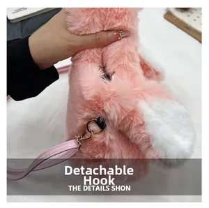 Detail of pink plush bag showing gold detachable metal hook and leather strap