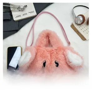 Detail of pink plush bunny crossbody bag with long ears and embroidered cute face