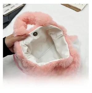 Detail of pink plush rabbit handbag showing white lining and magnetic metal closure