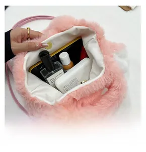Interior view of pink plush rabbit bag showing storage space for phone and lipstick
