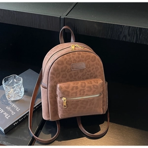 Detail view of the leopard print backpack with gold zipper and CAEKYD logo