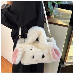 Detail of white plush rabbit handbag with long ears and golden metal strap hooks