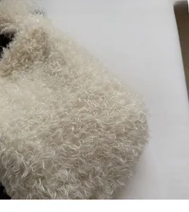 Detailed close-up showing the soft texture of the creamy white plush fleece tote bag fabric