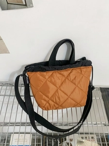 Quilted brown nylon bucket bag with black drawstring closure and shoulder strap
