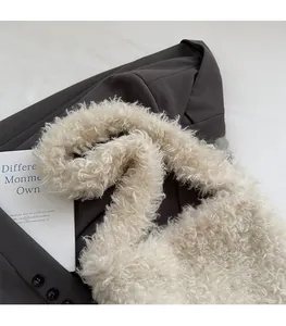 Detail of soft cream plush tote bag texture with comfortable wide shoulder strap