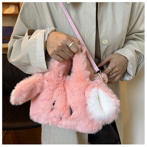 Close-up of pink plush bunny handbag with faux fur texture and adjustable strap