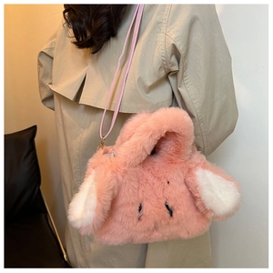 Detail of pink faux fur rabbit ear handbag with plush texture and detachable strap