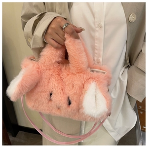 Close-up of pink plush bunny handbag featuring soft faux fur texture and long cute ears
