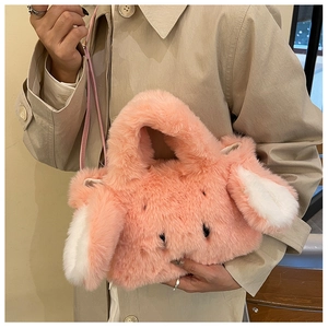 Detailed view of the pink plush rabbit ear handbag with a long adjustable shoulder strap