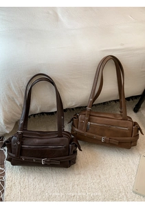 Detailed view of vintage faux leather shoulder bags in coffee and camel colors
