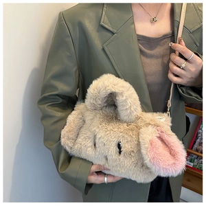 Detail of plush rabbit-themed handbag with long fuzzy ears and soft faux fur texture