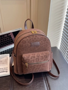 Chic leopard print brown leather backpack with gold zippers and spacious compartments