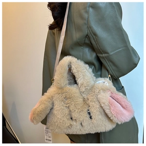 Detail of cute plush bunny crossbody bag with faux fur texture and pink ears accent