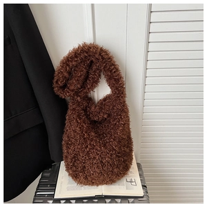 Detail shot of brown plush faux shearling texture on a stylish autumn crossbody bag