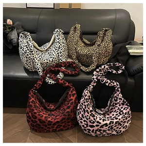 Detail of four leopard print fabric tote bags with zipper in various color patterns