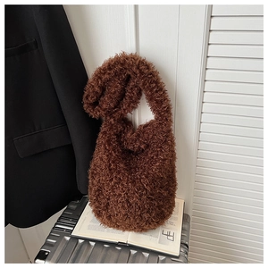 Detail of soft brown faux fur texture and long shoulder strap on plush tote bag