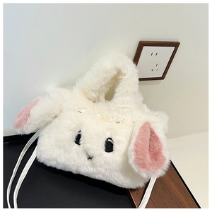 Detail of soft white faux fur rabbit handbag with pink ears and embroidered facial features