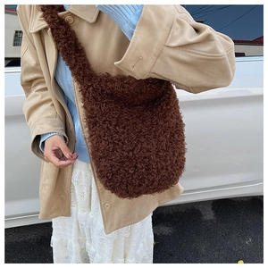 Detail of dark brown plush teddy fabric texture on a soft winter crossbody tote bag