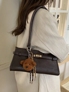 Retro dark brown shoulder bag with gold turn-lock and teddy bear plush charm