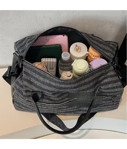 Detail view of large capacity fitness bag interior with compartments for daily essentials