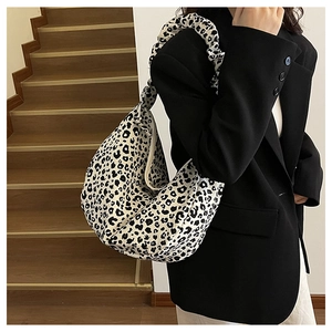 Close-up of leopard print hobo bag with unique ruched handle and half-moon design