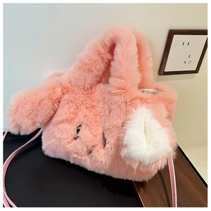 Detail of pink plush rabbit handbag with cute ears and soft faux fur texture