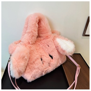 Close-up of a pink plush rabbit ear bag with soft faux fur texture and long strap