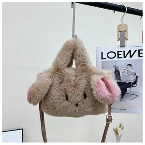 Detailed view of plush rabbit bag with pink ears and adjustable leather shoulder strap