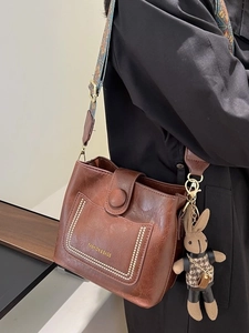 Retro brown leather bucket bag with jacquard wide strap and cute rabbit pendant
