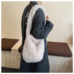Close-up of beige plush tote bag texture with thick teddy fleece material and soft lining