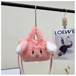 Detail of pink plush rabbit ear handbag with cute embroidery and leather handle