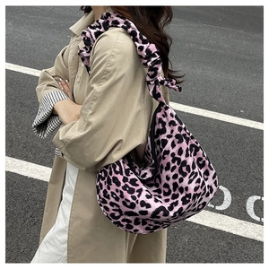 Close-up of pink leopard print bag featuring a trendy ruffled elastic shoulder strap