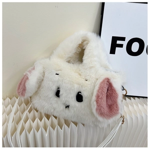 Close-up of white plush bunny handbag featuring pink floppy ears and soft faux fur texture