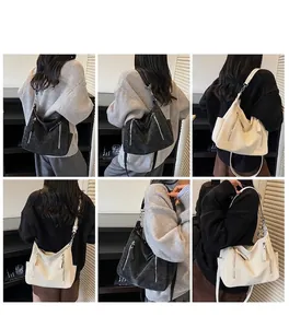 Detail view of large faux leather tote bags in black and beige with adjustable straps