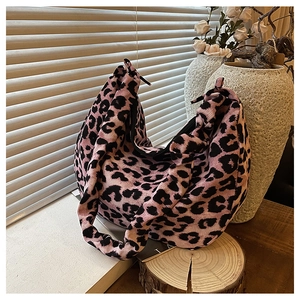 Detail of pink corduroy tote bag with leopard print texture on a lifestyle setting