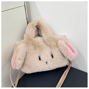 Detail showing the plush rabbit ear design and embroidery on the beige crossbody bag