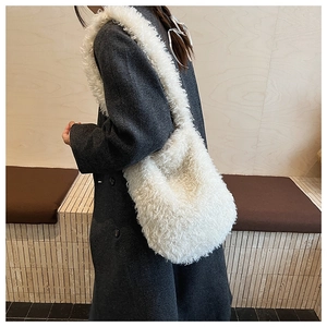 Close-up of white plush faux fur tote bag showing soft texture and shoulder strap