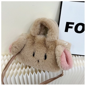 Detailed macro view of cute plush rabbit bag with pink long ears and soft brown fur texture