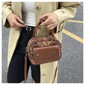 Brown paisley vintage Boston bag with leather flap pocket shown on model crossbody style