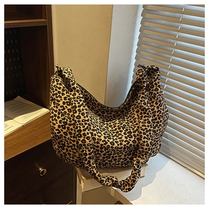 Detailed view of the leopard print tote bag fabric with natural pleated edge and wide strap