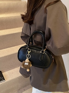 Retro black grain leather bowling handbag with plush monster charm and top handles
