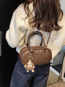 Retro brown bowling bag with letter embossing and plush charm accessory for women