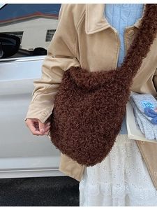 Brown faux shearling shoulder bag with a soft texture and elegant crescent shape