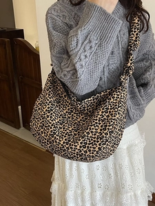 Leopard print canvas hobo bag with wide shoulder strap shown on model for daily styling
