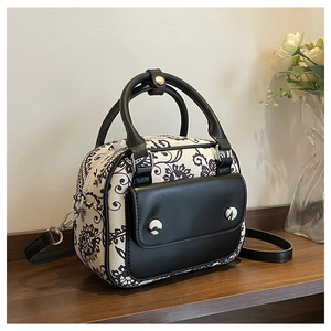 Detailed macro view of retro baroque floral mini bag on a wooden surface in studio setting