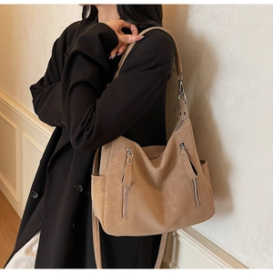 Side view of camel vintage tote bag with dual zipper pockets on high-quality matte leather