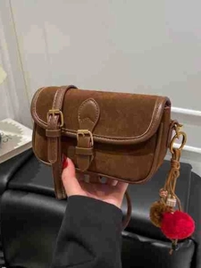 Vintage dark brown square shoulder bag with matte texture and decorative metal buckles