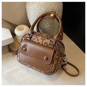 Detail of vintage floral pattern Boston bag with leather flap pocket and silver hardware